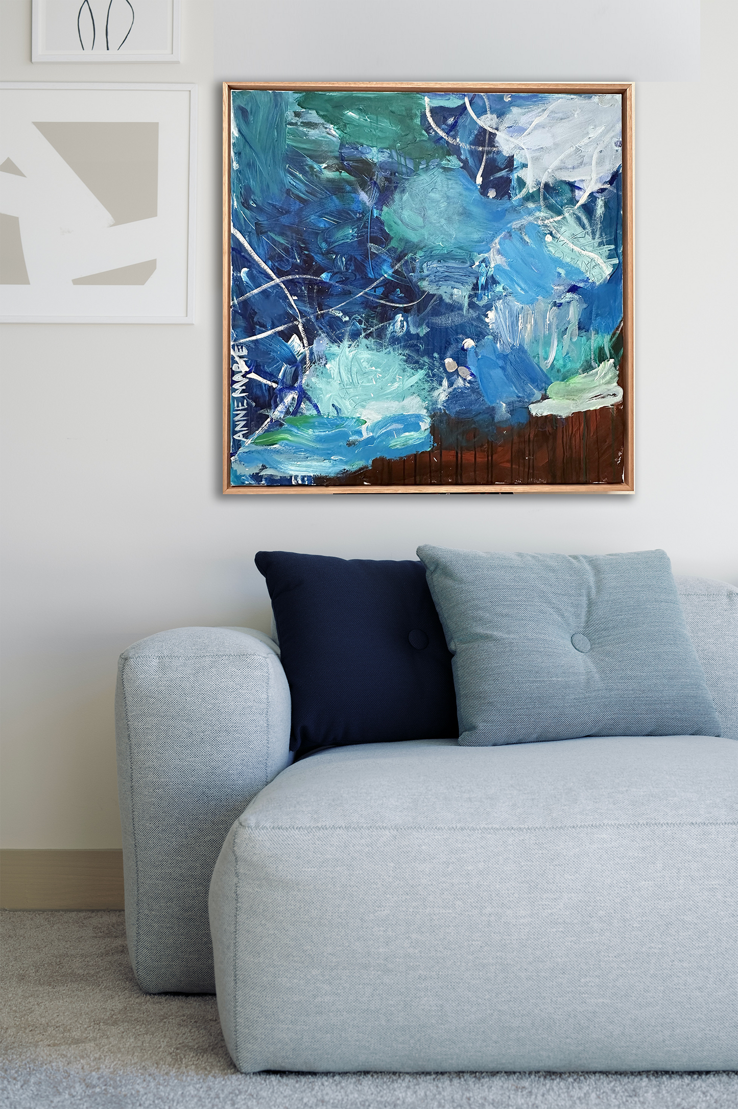 Blue, green, rust, brown and white abstract artwork. Abstract landscape. Seascape. Fairy Bower Sea. Manly beach. Interior design. On trend art. Home decor. Silver paint. Blue. Navy. White. Aqua. green. Aquamarine. Framed artwork in modern lounge room with grey lounge.