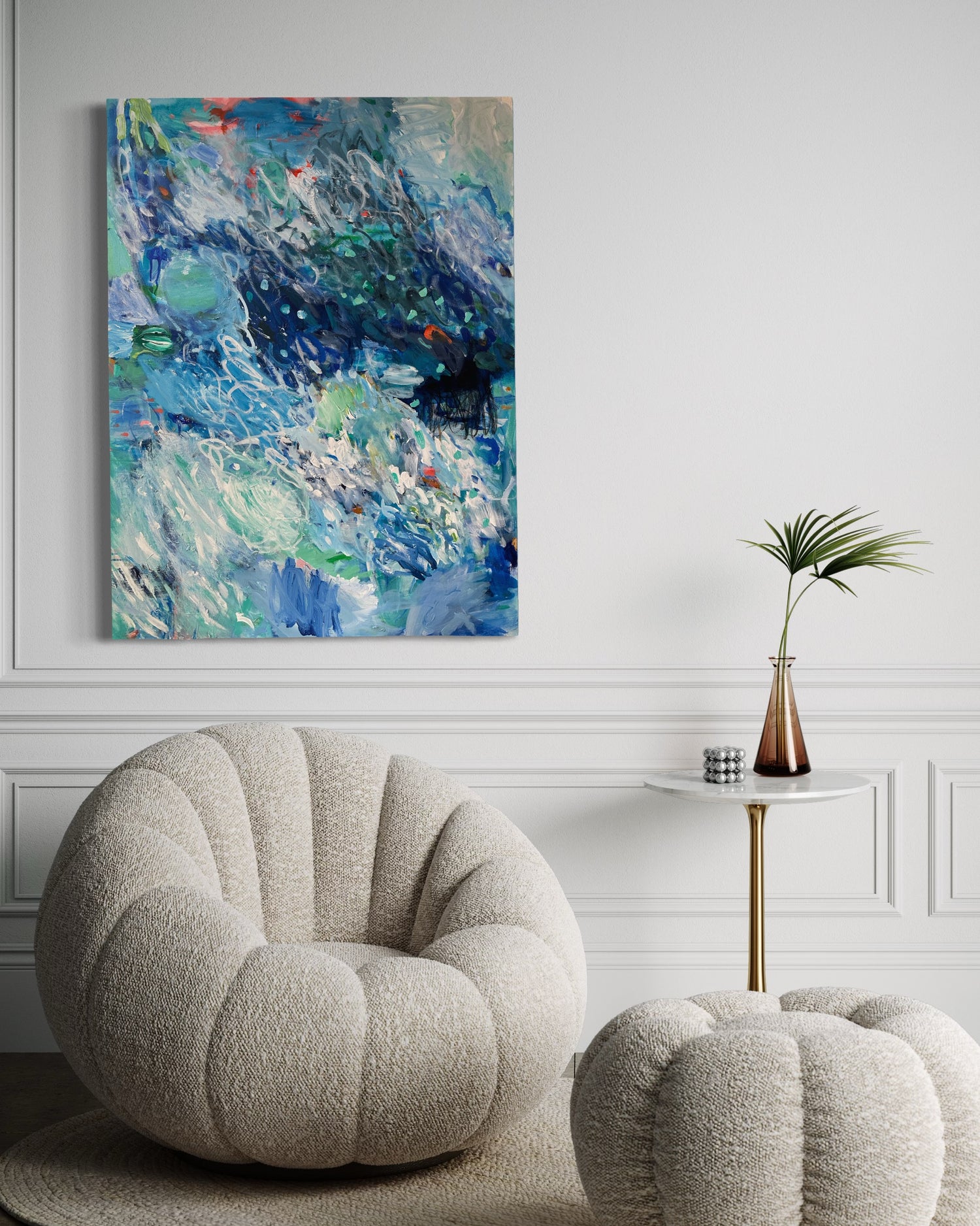 An ocean inspired abstract painting in the colours of blue, green and sparks of orange. Home decor. Interior design. Decorative art. Blue art. Affordable art. Dinning room with artwork.