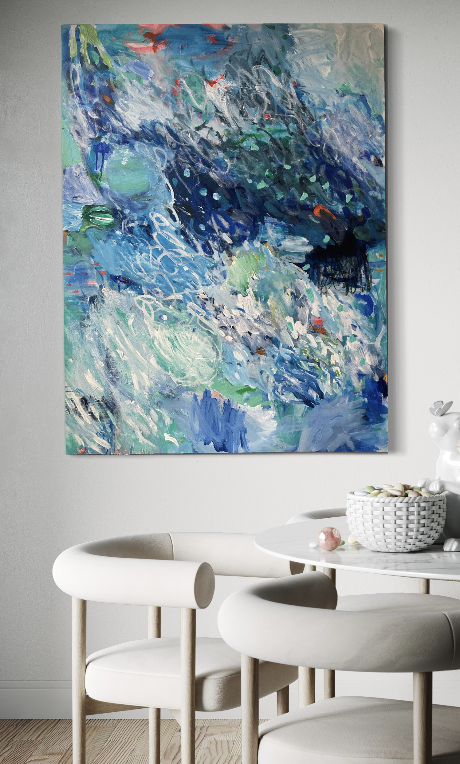 An ocean inspired abstract painting in the colours of blue, green and sparks of orange. Home decor. Interior design. Decorative art. Blue art. Affordable art. Dinning room with art. White dining chairs. Modern art